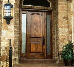 a wooden door sitting on the side of a brick building next to a lamp post