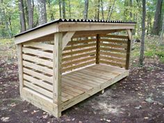 a small wooden shelter in the woods