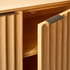 a close up of a wooden cabinet with sliding doors and wood slats on it