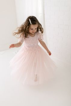 The Perfect Sienna Flower Girl Dress with very soft blush pink lace on the neckline and floor-length tulle skirt adds extra elegance to the dress. Princess Style Lace Dress For Dress-up, Princess Dress With Lace Bodice And Tulle For Dress-up, Tulle Dress With Lace Trim For Dress-up, Fitted Lace Dress With Lace Sleeves For Dress-up, Elegant Bridesmaid Tutu Dress With Lace Trim, Princess Bridesmaid Dress With Lace Trim, Wedding Tutu Dress With Lace Bodice, Bridesmaid Princess Dress With Lace Trim, Delicate Lace Bodice Dress For Spring