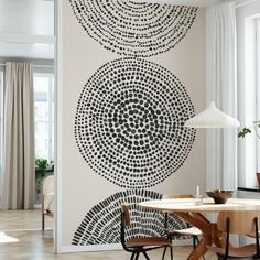 a dining room wall decorated with black and white circles