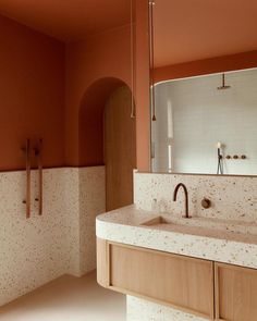 a bathroom with two sinks and a mirror in the middle of it, along with an arched doorway leading to another room