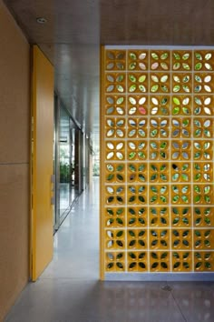 a hallway with a wall made out of glass bottles