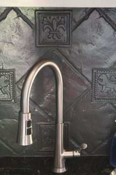 a faucet mounted to the side of a kitchen sink next to a wall