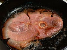 meat is cooking in a skillet on the stove