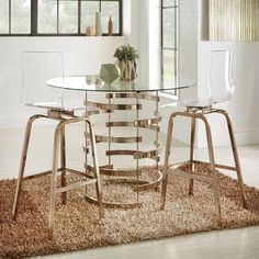 a glass table with two stools in front of it on a shaggy area rug