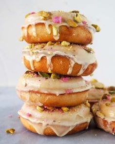 a stack of doughnuts with frosting and sprinkles