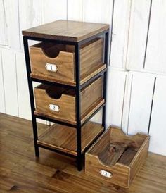 three wooden drawers sitting on top of a hard wood floor