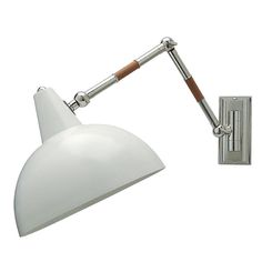 a white wall light with a wooden arm on a white background and an angle lamp attached to it