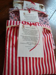 red and white striped wrapping paper on top of each other with a note attached to it