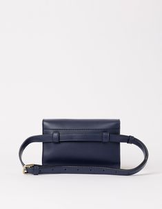 Sanne Vogel x O My Bag Born from a shared love for bags and a passion for sustainability, actress and writer Sanne Vogel and O My Bag designed the Sanne Belt Bag. Keys? Cards? Phone? Check! This belt bag's got space for all your essentials, leaving your hands free to take on the day. The navy colorway adds a touch of class to any outfit. This bag is our first bag designed to be worn on the waist, and our first style that is available exclusively in Vegan Uppeal. Do you want to wear your Sanne cr Modern Rectangular Belt Bag For On-the-go, Luxury Top Handle Belt Bag For Everyday Use, Travel Belt Bag With Detachable Strap And Top Handle, Modern Tote Belt Bag For Travel, Luxury Satchel Belt Bag For Everyday, Luxury Everyday Satchel Belt Bag, Modern Belt Bag Tote For Travel, Luxury Belt Bag Satchel For Everyday Use, Everyday Pouch Box Bag With Detachable Strap