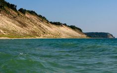 the water is very choppy and blue in this photo, it looks to be calm