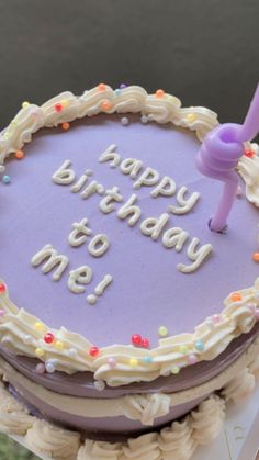 a purple birthday cake with the words happy birthday to me on it and a candle