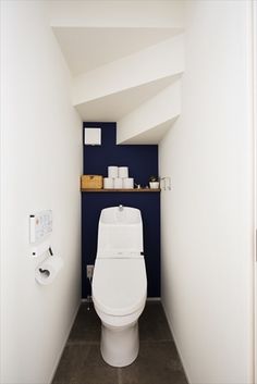 a white toilet sitting in the corner of a bathroom