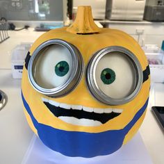 a yellow and blue painted pumpkin with eyes