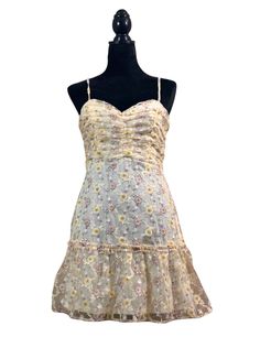 Pastel Yellow Floral Lace Dress There's strength in the delicate beauty of flowers. This special dress is made of mesh fabric finely embroidered with yellow and purple flowers and a filigree lace pattern, over stretchy solid fabric. It features a sweetheart neckline. The top of the dress has rouching and is double lined for extra coverage. The skirt is two-tiered with ruffle detail. This dress zips at the back and has adjustable spaghetti straps. Dress is approximately 28" long from the neckline Spring Sheer Dress With Fitted Bodice, Spring Sheer Dress With Sweetheart Neckline, Sheer Lace Dress With Spaghetti Straps For Spring, Spring Fitted Lace Dress With Spaghetti Straps, Yellow Fitted Dress With Sweetheart Neckline, Summer Lace Dress With Fitted Bodice, Mini Length, Spring Lace Mini Dress With Sweetheart Neckline, Sheer Fitted Lace Summer Dress, Spring Mini Lace Dress With Delicate Lace