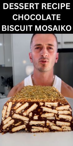 a man sitting in front of a cake with chocolate frosting on it and the words dessert recipe chocolate biscuit mosaiko