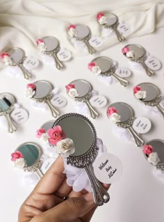 a person holding up a mirror with flowers on it next to several mirrors that say i love you