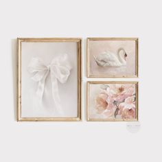 three framed paintings with flowers and a white swan in the middle one has a bow on it's head