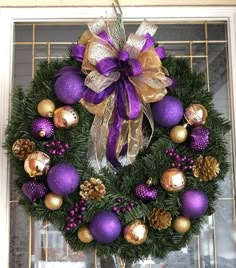 a wreath with purple and gold ornaments on it