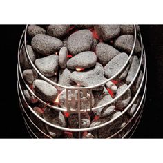 a metal container filled with rocks on top of a table