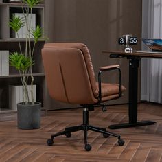 a brown leather office chair sitting in front of a desk with a clock on it