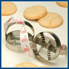 cookie cutters and cookies on a white surface with blue border around them, including one cookie