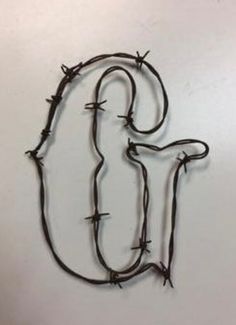 barbed wire with the letter j on it's side and an image of a bird in the middle