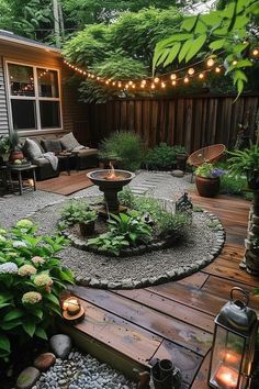 an outdoor patio is lit up with lights and landscaping items in the back yard, surrounded by greenery