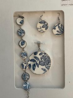 three pieces of blue and white jewelry in a box