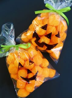 two bags filled with candies shaped like jack - o'- lantern pumpkins