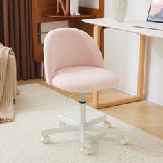 a pink office chair sitting on top of a white rug in front of a desk