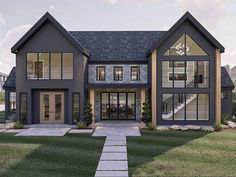 a large gray house with lots of windows on it's sides and stairs leading up to the front door