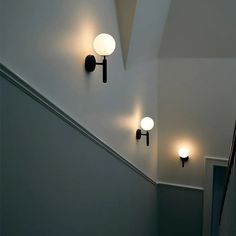 three lights are on the wall in an empty room