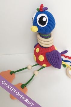 a crocheted toy sitting on top of a white table next to a wooden object