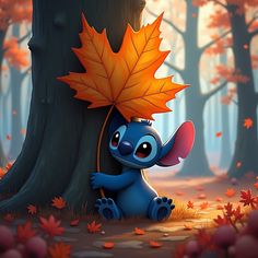 an image of a cute little blue elephant hiding behind a tree with autumn leaves on it