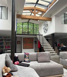 a living room filled with furniture and a staircase