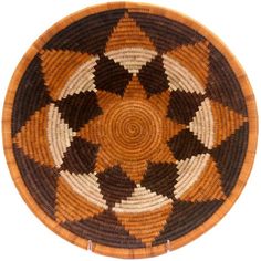 a brown and black woven basket sitting on top of a table