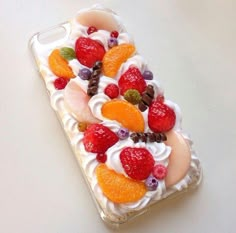 a cell phone case with fruit on it sitting on top of a white countertop