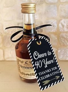 a bottle of wine with a tag that says cheers to 40 years thanks for celebrating