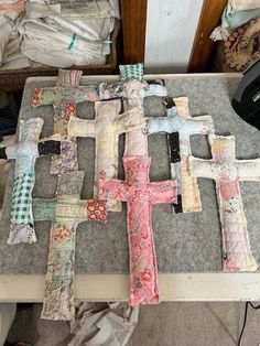 a cross made out of fabric sitting on top of a table