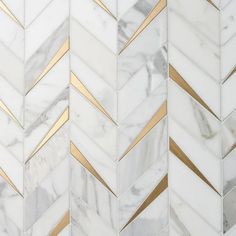 white and gold herringbone marble tile with metallic lines on the sides, diagonals