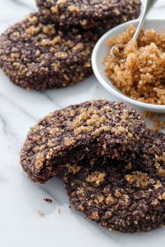 chocolate cookies with crumbs and a bowl of oatmeal on the side