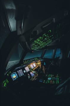 the inside of an airplane cockpit with green lights