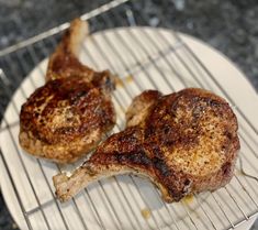 two pieces of meat sitting on top of a grill