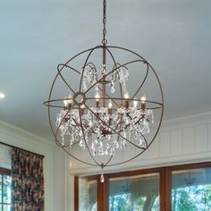 a chandelier hanging from the ceiling in a dining room