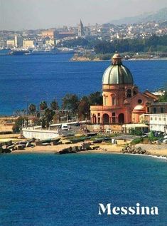 an old building with a dome on the top is in front of some water and buildings