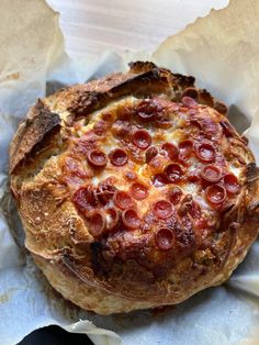 a pizza sitting on top of a piece of wax paper