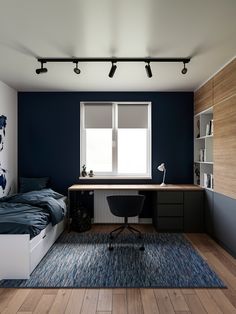 a bedroom with a bed, desk and bookshelf next to a large window