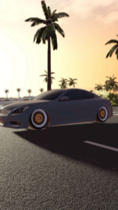 a car is driving down the road in front of some palm trees at sunset or dawn